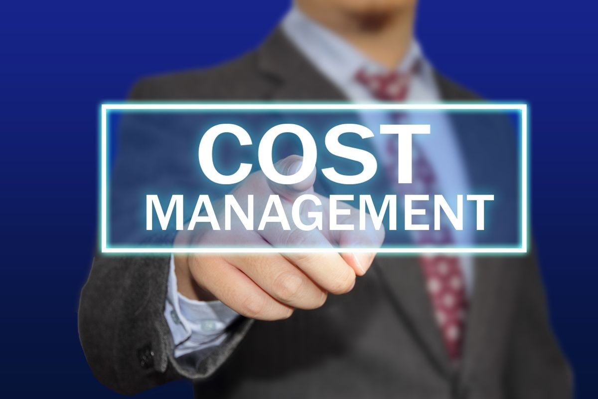 Business concept image of a businessman clicking Cost Management button on virtual screen over blue background