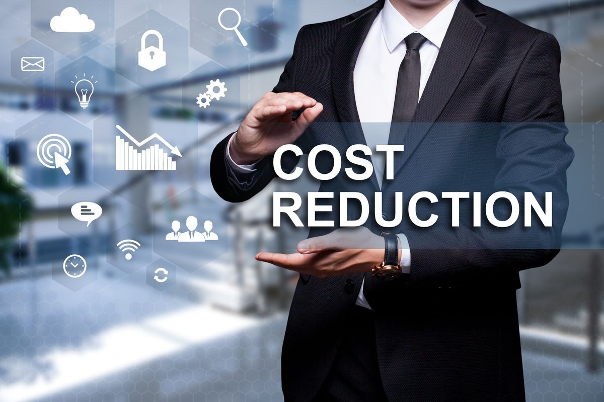 White text with icon "Cost Reduction" in the hands of a businessman. Business concept. Internet concept.